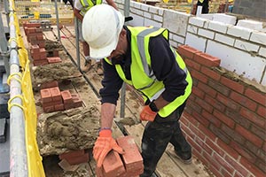 construction worker using social distancing device